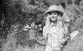 Happy childhood. Child in hat with shoulder blade small shovel hoe. Happy smiling gardener girl. Ranch girl. Planting Royalty Free Stock Photo