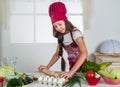 happy childhood. happy child wear cook uniform. chef girl in hat and apron. kid cooking food in kitchen. choosing a Royalty Free Stock Photo