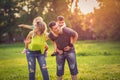 Happy Childhood-Funny parents giving children piggyback ride in park Royalty Free Stock Photo