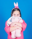 Happy childhood. Get in easter spirit. Bunny ears accessory. Lovely playful bunny child hugs soft toy. Have blessed