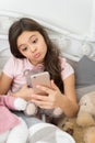 Happy childhood. Girl with smartphone use modern technology. Selfie with favorite toy. Send selfie photo your friends Royalty Free Stock Photo