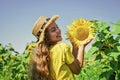 happy childhood. kid wear straw summer hat. child in field of yellow flowers. teen girl in sunflower field. concept of Royalty Free Stock Photo