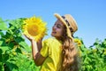 happy childhood. kid wear straw summer hat. child in field of yellow flowers. teen girl in sunflower field. concept of Royalty Free Stock Photo