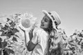 happy childhood. kid wear straw summer hat. child in field of yellow flowers. teen girl in sunflower field. concept of Royalty Free Stock Photo