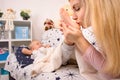 Young Mother kissing baby Feet. Happy childhood, love family Royalty Free Stock Photo