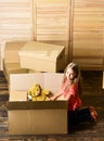 Happy childhood. Relocating family stressful for kids. Kid girl relocating boxes background. Relocating concept