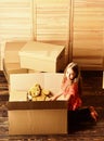 Happy childhood. Relocating family stressful for kids. Kid girl relocating boxes background. Relocating concept