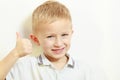 Happy childhood. Smiling blond boy child kid showing thumb up Royalty Free Stock Photo