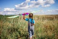 Happy childhood and summertime. Kid having fun and playing with a kite, outdoor Royalty Free Stock Photo