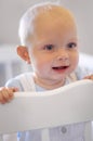 Happy, children and baby in the crib of a nursery in his home for growth, child development or curiosity. Kids, bedroom Royalty Free Stock Photo