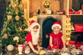 Happy children bake and decorate Christmas cookies. Funny Kids in kitchen making christmas cookies. Funny children Royalty Free Stock Photo