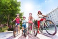Happy children with bicycles in summer city Royalty Free Stock Photo
