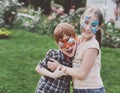 Happy children, boy and girl with face paint in park Royalty Free Stock Photo