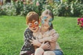 Happy children, boy and girl with face paint in park Royalty Free Stock Photo