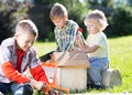 Happy children boys brothers tinkering outdoors