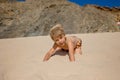 Happy children, boys, playing on the beach on sunset, kid cover in sand, smiling, laughing Royalty Free Stock Photo