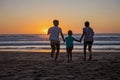 Happy children, boys, playing on the beach on sunset, kid cover in sand, smiling, laughing Royalty Free Stock Photo