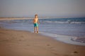 Happy child, boy, playing on the beach on sunset, kid cover in sand, smiling Royalty Free Stock Photo