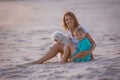 Happy children, boys, playing on the beach on sunset, kid cover in sand, smiling, laughing Royalty Free Stock Photo