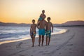 Happy children, boys, playing on the beach on sunset, kid cover in sand, smiling, laughing Royalty Free Stock Photo