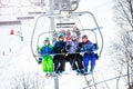 Happy children in bright ski outfit on chairlift Royalty Free Stock Photo