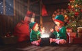 happy children brother and sister elf, helper of Santa with Christmas magic gifts Royalty Free Stock Photo