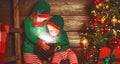 happy children brother and sister elf, helper of Santa with Christmas magic gifts Royalty Free Stock Photo