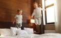 Happy children brother and sister jump on bed in bedroom Royalty Free Stock Photo