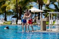 Happy children, brothers, having fun in the pool