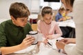 Happy children building robots at robotics school Royalty Free Stock Photo