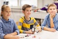 Happy children building robots at robotics school Royalty Free Stock Photo