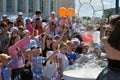 Happy children catch soap bubbles on the street in the city of T