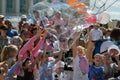 Happy children catch soap bubbles on the street in the city of T