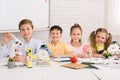 Happy children creating robots at stem class
