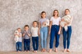 Happy children of different age with puppies standing in line