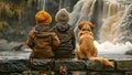 Happy children with dog family sitting by a river with waterfall, enjoying the hike to waterfall summertime on a cold