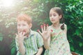 Happy children eating raspberry from fingers in summer garden Royalty Free Stock Photo