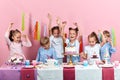 Happy children enjoying the party , isolated pink background,