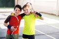 Happy children entertaining on tennis court Royalty Free Stock Photo