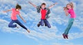 Happy children exercising and jumping in the blue sky Royalty Free Stock Photo