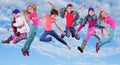 Happy children exercising and jumping in the blue sky Royalty Free Stock Photo