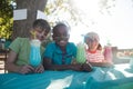 Happy children with face paint having drinks at park Royalty Free Stock Photo