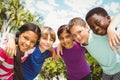 Happy children forming huddle at park