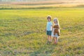 Happy children girl and boy running on meadow in summer in nature. Country life. Happy children farmers having fun on Royalty Free Stock Photo