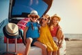 Happy children girls friends sisters on the car ride to summer trip Royalty Free Stock Photo