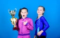 Happy children with gold champion cup. Acrobatics and gymnastics. Little girls hold jump rope. victory of teen girls