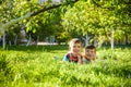 Happy children having fun outdoors. Kids playing in summer park. Little boy and his brother laying on green fresh grass holiday ca Royalty Free Stock Photo