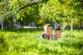 Happy children having fun outdoors. Kids playing in summer park. Little boy and his brother laying on green fresh grass holiday Royalty Free Stock Photo