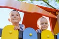 Two laughing boys outdoors play at summer time