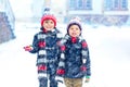 Happy children having fun with snow in winter Royalty Free Stock Photo